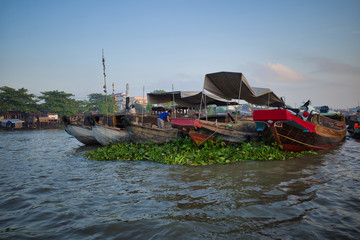 Can Tho, Vietnam - March 27, 2019: several seller boats bounded together on floating market in Mekong delta
