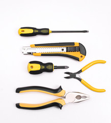 Black yellow tools - knife, pliers, tape measure, screwdriver, nippers on a white background. Place for text. Work inventory