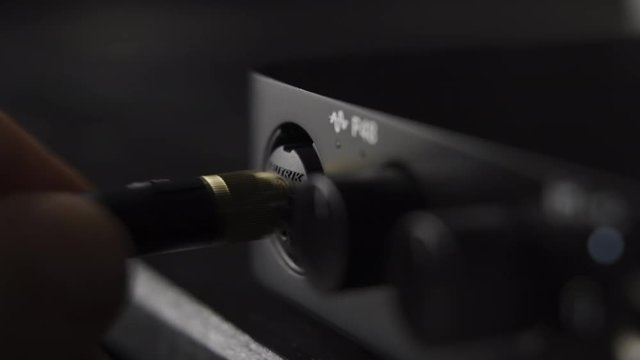 Plugging in electric guitar jack in audio interface at home music studio
