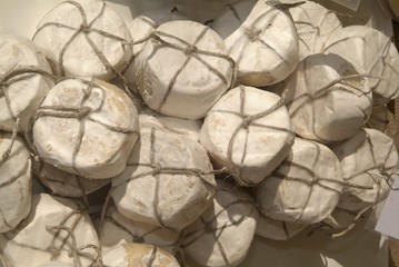 Forms with freshly made cheese on wooden table