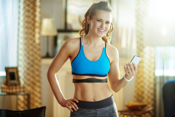 woman wearing heart rate monitor using in fitness app in mobile