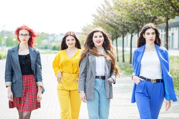 Four beautiful women are walking down the street. Concept of lifestyle, friendship, students