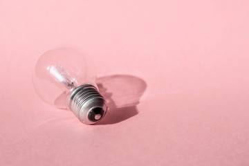Close up view of white light bulb isolated on pink.