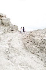 Wedding Couple at the monument rocks in kansas hiking together in the wilderness with their dog