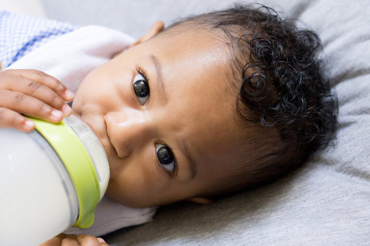 Baby Holding Bottle