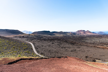 Timanfaya volcanoes park, Lanzarote, Canary Islands, Spain. Unique panoramic view of spectacular lava river flows from huge volcano craters creates a lunar landscape on planet earth.
