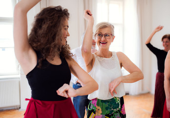 Group of senior people in dancing class with dance teacher.
