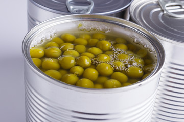 Canned green peas in a iron can on white background