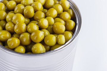 Canned green peas in a iron can on white background