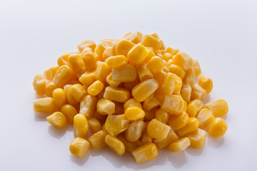 Canned corn on a white acrylic background