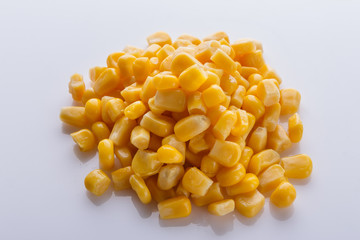 Canned corn on a white acrylic background