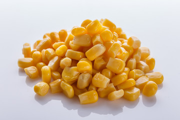 Canned corn on a white acrylic background