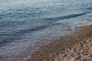 calming scenic landscape of sand empty beach along lake waterfront coast line 