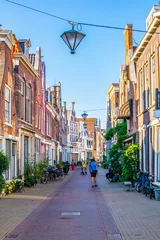 Foto op Canvas Classical red brick houses situated alongside Groot Heiligland street in Haarlem, Netherlands © dudlajzov