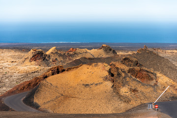 Timanfaya National Park martian landscape, Lanzarote, Canary Islands, Spain. Unique panoramic view of spectacular  volcano cones and craters craters near atlantic ocean shoreline.