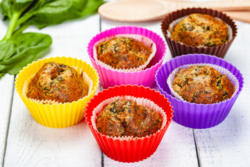 Muffins with basil and spinach on wooden rustic table. Close up