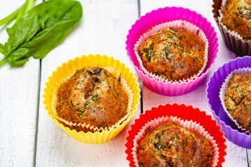 Muffins with basil and spinach on wooden rustic table. Close up