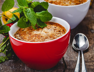 Apple crumble in two cups on wooden rustic background. Close up