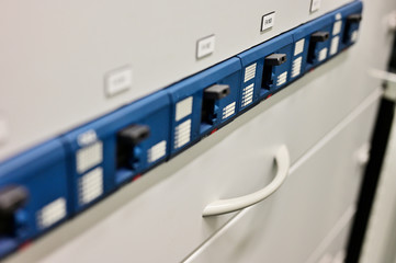 Large three-phase circuit breakers in the control cabinet.