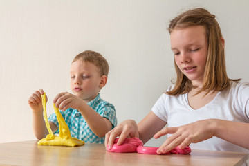 Obraz na płótnie Canvas Children play with slime. Happy childhood