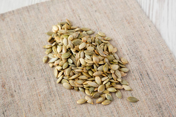 Roasted pumpkin seeds on cloth, low angle view. Close-up.