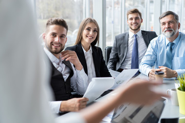 Businesswoman Leads Meeting Around Table. Discussion Talking Sharing Ideas Concept.