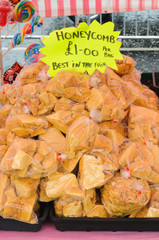 Bags of honeycomb at a market stall.