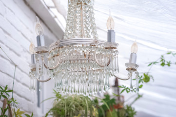 Antique vintage crystal chandelier in rustic style close up and copy space