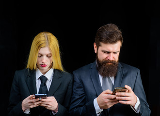Handsome businessman&businesswoman with mobile phone. Business team working on smartphones. Business couple chatting with mobile phone. Businessperson using smart phones. People working mobile devices