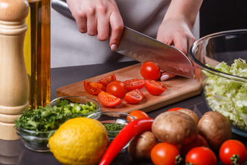 young woman in a gray apron cherry tomatoes
