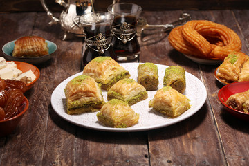 Middle eastern or arabic dishes. Turkish Dessert Baklava with pistachio on dishes