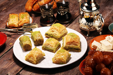 Middle eastern or arabic dishes. Turkish Dessert Baklava with pistachio on dishes