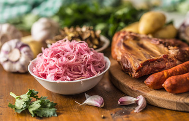 Sour cabbage dried mushrooms smoked pork ribs sausages garlic potatoes and celery herbs