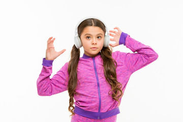 Time to rest. Active girl enjoy music playing in earphones. Athletic little girl relaxing isolated on white. Cute girl child listening to music. Fit small girl wearing headphones