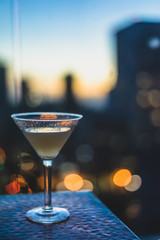Closeup of cocktail overlooking city