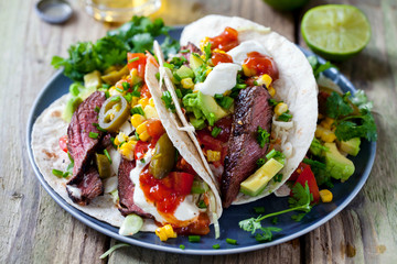 Soft tacos with fillet steak, sweetcorn, coleslaw, avocado and tomato salsa
