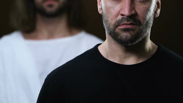 Jesus Christ putting hand on nervous man shoulder, helping to make right choice
