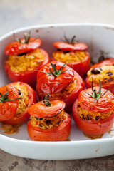 Roast tomatoes stuffed with rice, pine nuts and raisins