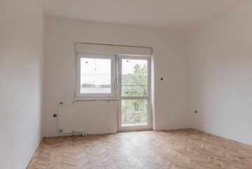 renovation of the house.white empty room with parquet and pvc windows.