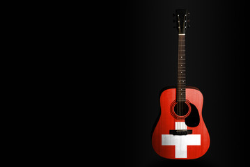 Fototapeta na wymiar Acoustic concert guitar with a drawn flag Switzerland, on a dark background, as a symbol of national creativity or folk song.