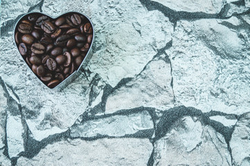 heart shaped coffee beans on stone