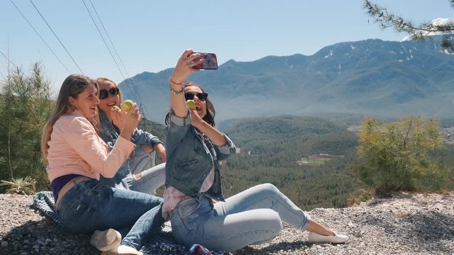 Three young women taking selfie with mobile phone