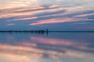 Obraz premium lighthouse on the river and bright sunset