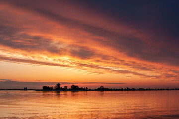 dark orange sunset spring evening on the river or reservoir