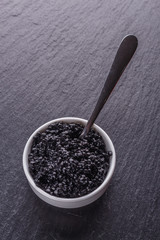 black caviar in a bowl on a dark stone background