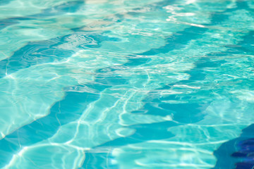 Water in swimming pool with sun reflection