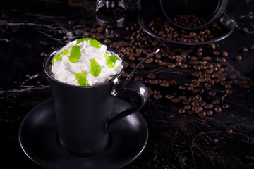 frappe coffee with whipped cream and syrup on dark background