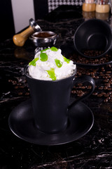 frappe coffee with whipped cream and syrup on dark background