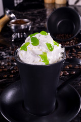 frappe coffee with whipped cream and syrup on dark background