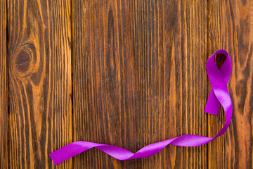 International day against homophobia, transphobia and biphobia. Purple ribbon, homophobia symbol, transphobia and biphobia on wooden background with space for text